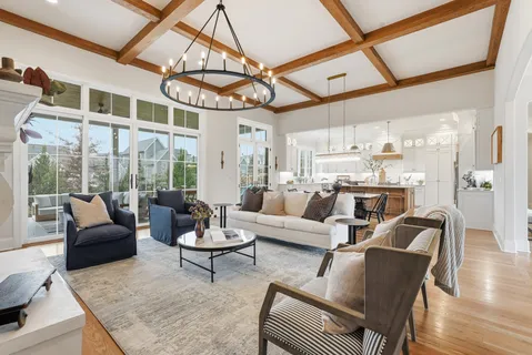a living room with furniture a rug and a chandelier