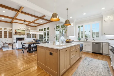 a kitchen with stainless steel appliances granite countertop a sink a stove top oven a counter space and cabinets