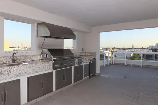 a kitchen with stainless steel appliances granite countertop a stove and a sink