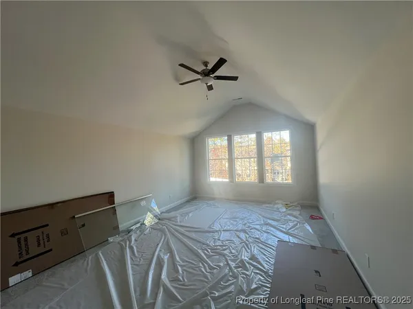 a view of a livingroom with a ceiling fan and window