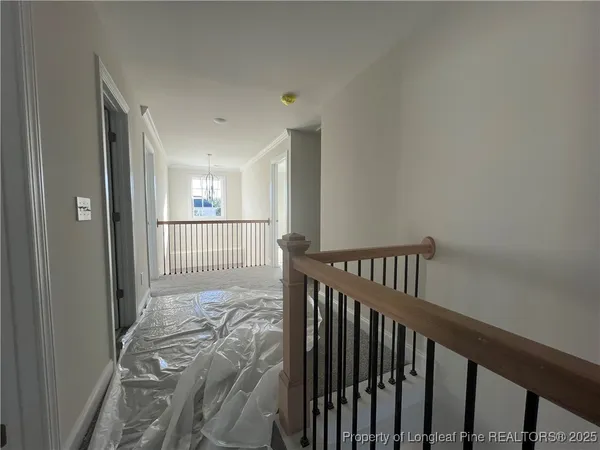 a view of a hallway with a bed