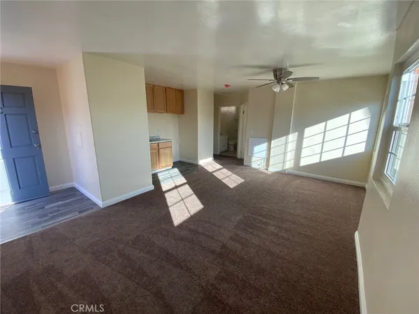 en empty room with windows and outdoor view