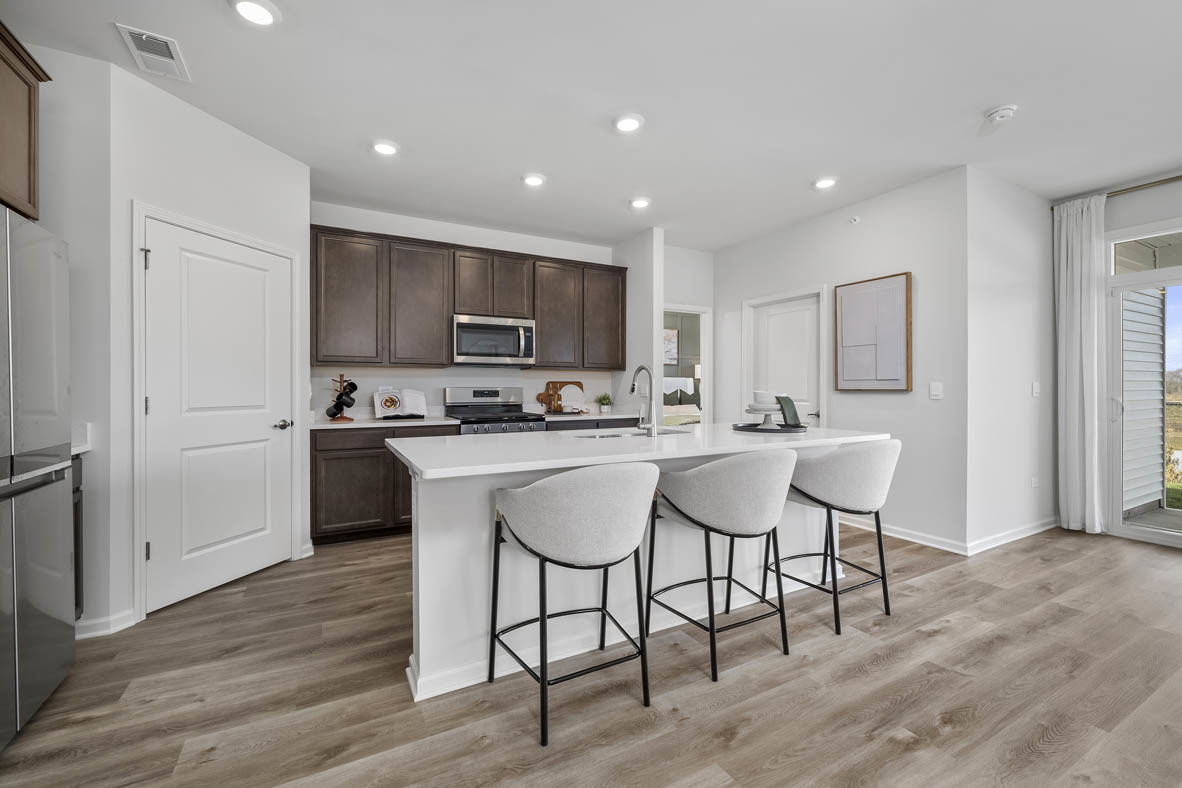 1390 Wild Tulip Circle Bartlett, IL 60103 - Photo 12 of 21 a kitchen with a sink cabinets and wooden floor