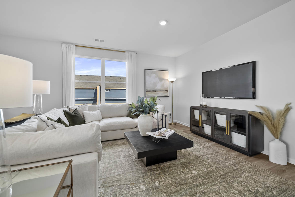 1390 Wild Tulip Circle Bartlett, IL 60103 - Photo 13 of 21 a living room with furniture and a flat screen tv