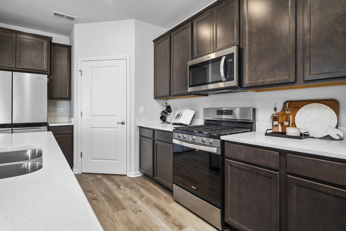 1390 Wild Tulip Circle Bartlett, IL 60103 - Photo 15 of 21 a kitchen with stainless steel appliances granite countertop a stove microwave and refrigerator