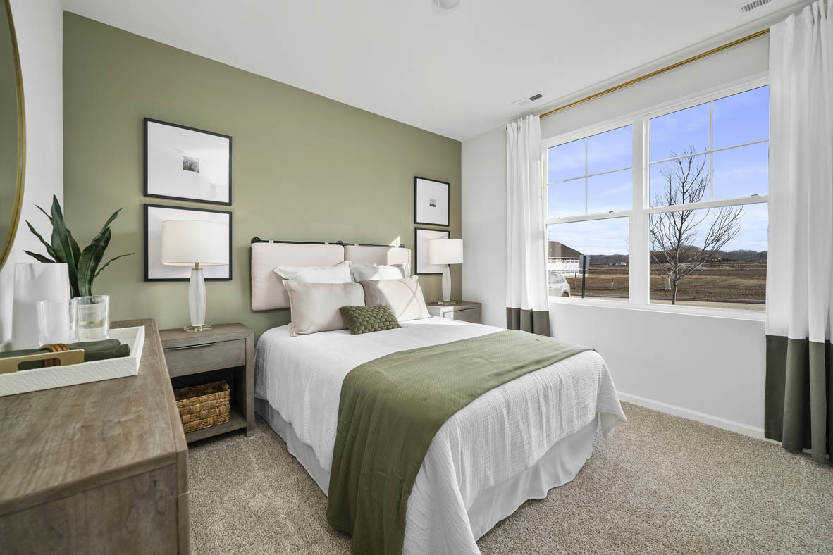 1390 Wild Tulip Circle Bartlett, IL 60103 - Photo 3 of 21 a bedroom with a bed a table and chair with the large mirror