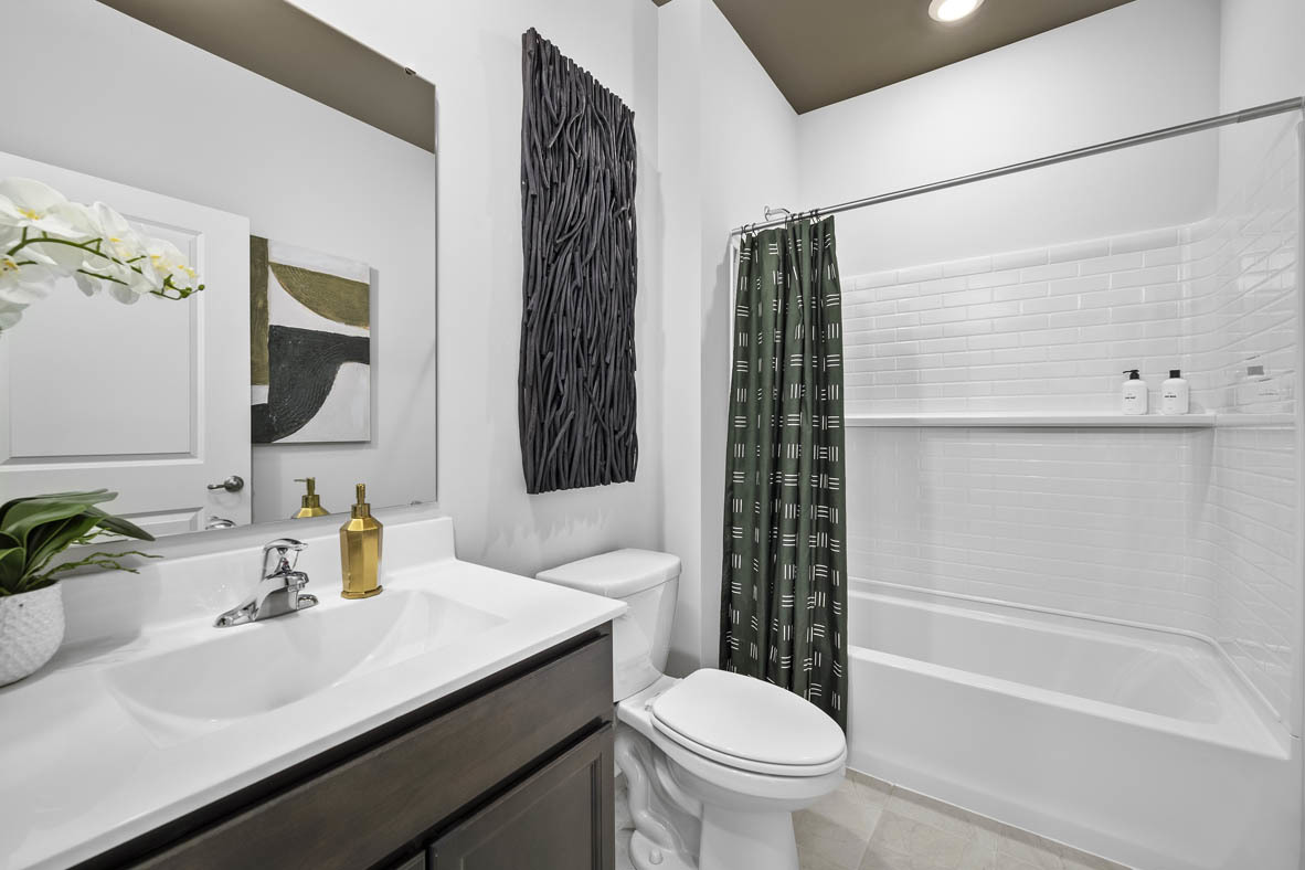 1390 Wild Tulip Circle Bartlett, IL 60103 - Photo 4 of 21 a bathroom with a sink toilet and shower