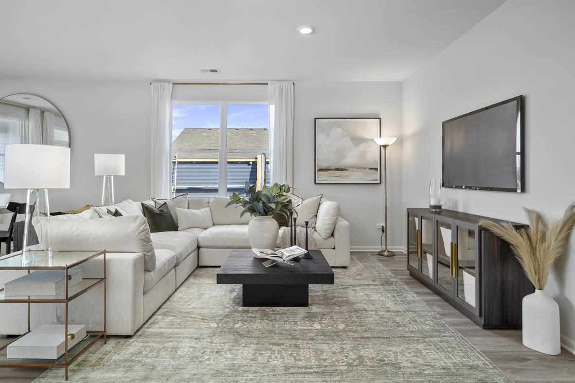 1390 Wild Tulip Circle Bartlett, IL 60103 - Photo 7 of 21 a living room with furniture and a flat screen tv