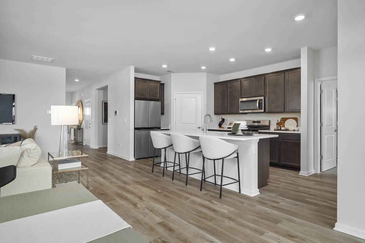 1390 Wild Tulip Circle Bartlett, IL 60103 - Photo 10 of 21 a large kitchen with kitchen island a white cabinets and stainless steel appliances