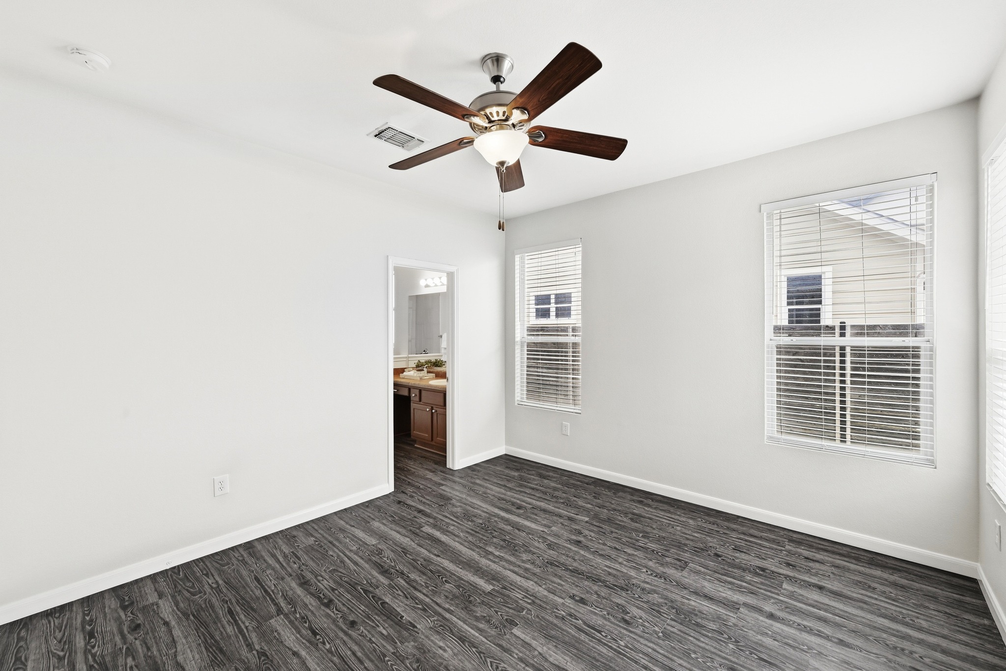 2133 Emma Long Street Austin, TX 78723 - Photo 13 of 39 Large windows bring in natural light to the comfortable primary suite.