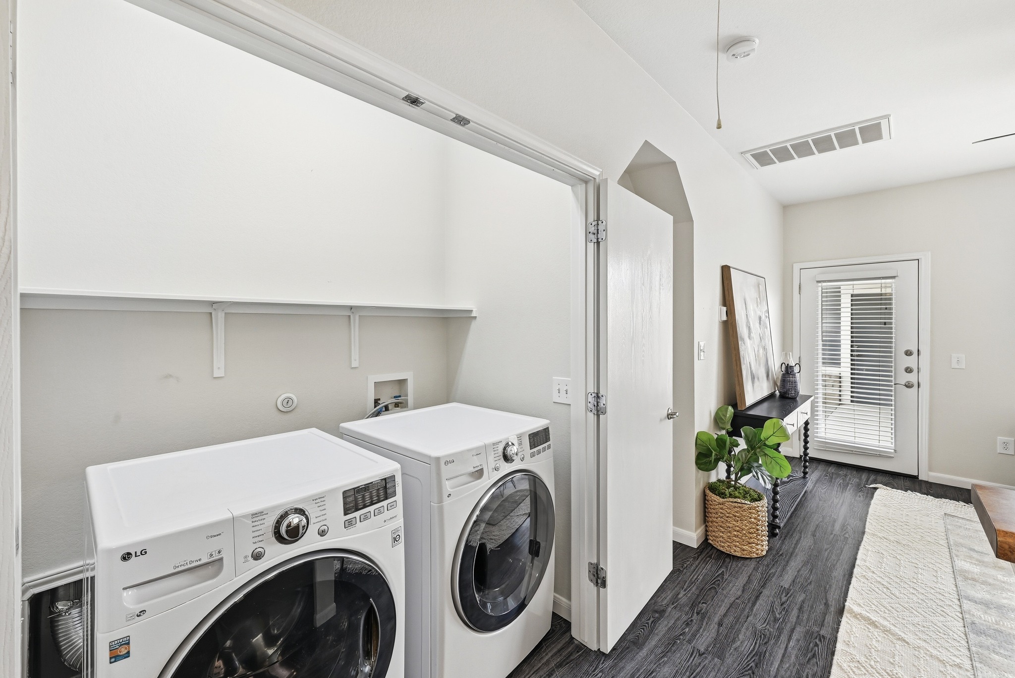 2133 Emma Long Street Austin, TX 78723 - Photo 21 of 39 Functional laundry closet keeps the washer and dryer neatly tucked away.
