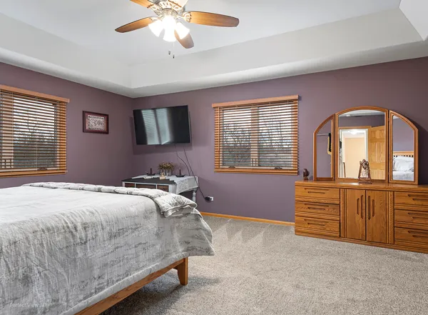 a bedroom with a bed and a dresser