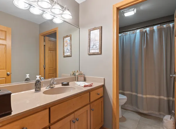 a bathroom with a sink a light fixture and a mirror
