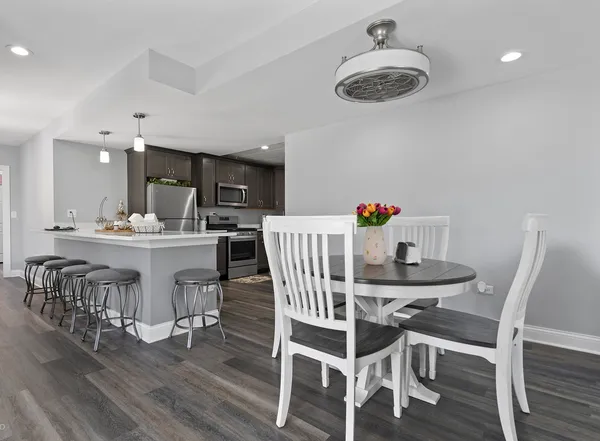 a view of a dining room with furniture and wooden floor
