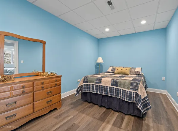 a bedroom with a bed and a dresser