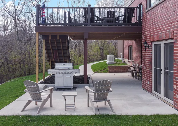 a view of house with backyard and outdoor seating
