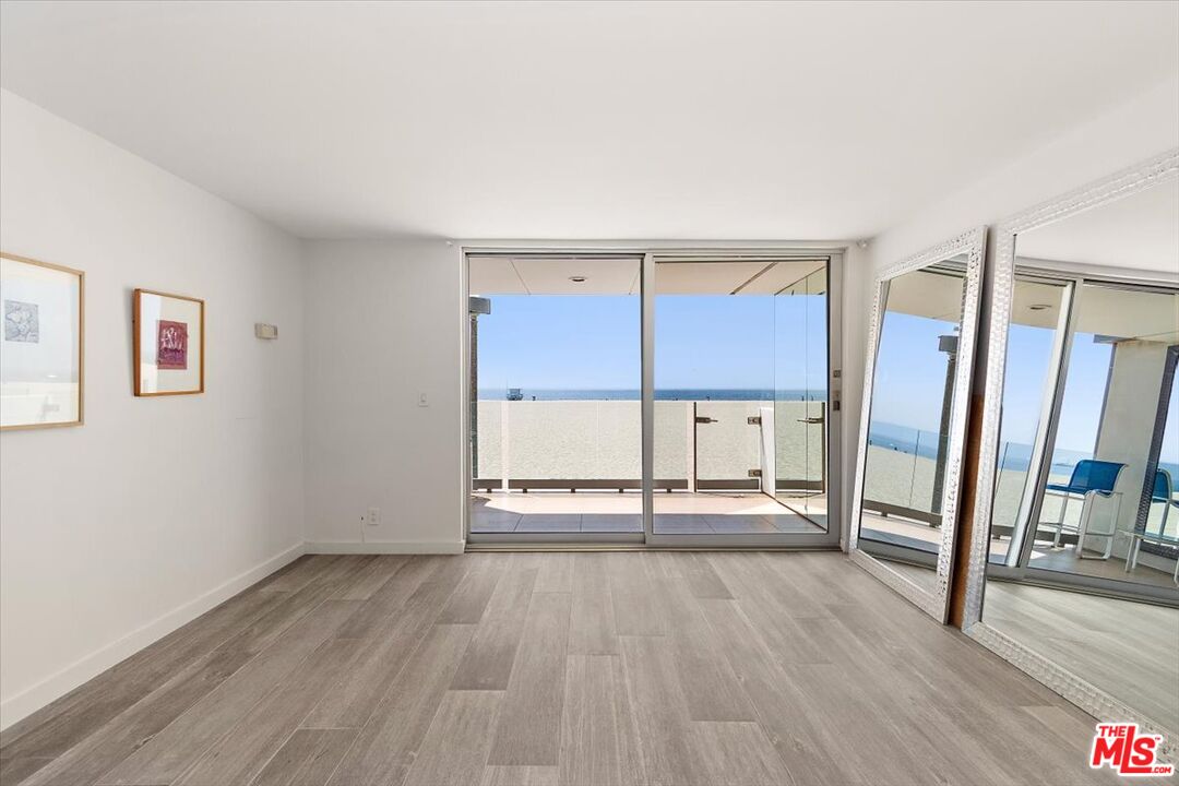 4 Jib Street, Unit 2 Marina del Rey, CA 90292 - Photo 11 of 37 an empty room with wooden floor and door