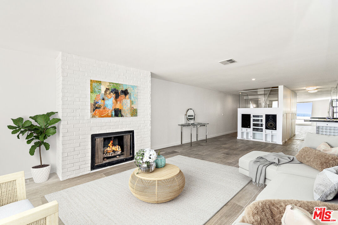 4 Jib Street, Unit 2 Marina del Rey, CA 90292 - Photo 7 of 37 a living room with furniture and a fireplace