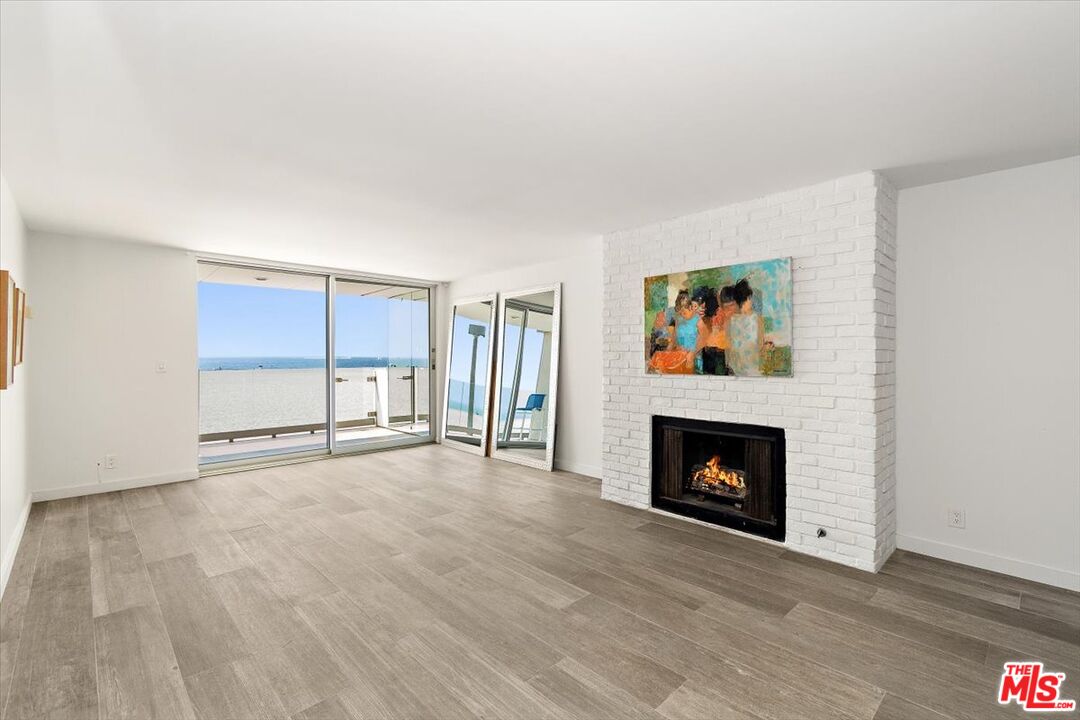 4 Jib Street, Unit 2 Marina del Rey, CA 90292 - Photo 9 of 37 a view of an empty room with a fireplace and a window