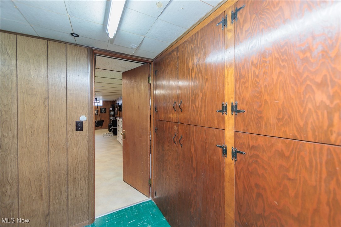 6901 Revere Road Cleveland, OH 44130 - Photo 41 of 50 Hall with a paneled ceiling and wooden walls