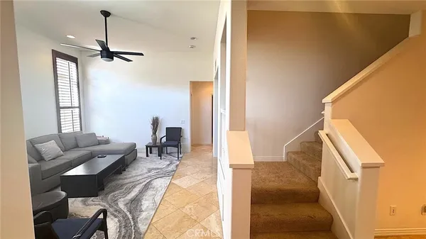 a dining room with furniture and a floor to ceiling window