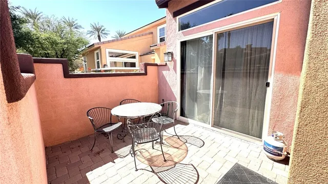 a backyard of a house with table and chairs