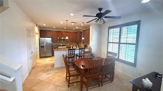 a view of a dining room with furniture and a chandelier