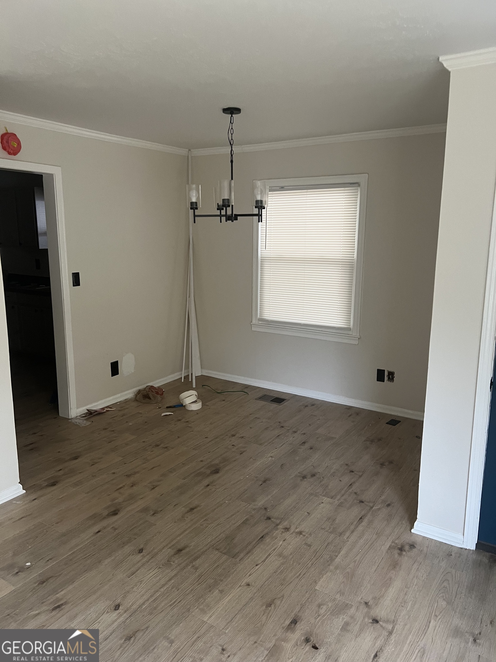 784 Spring Valley Drive Forest Park, GA 30297 - Photo 2 of 12 an empty room with wooden floor and windows