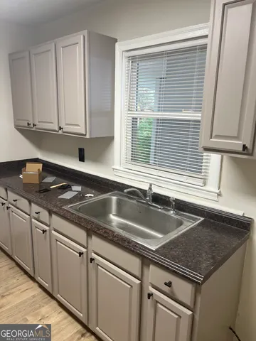 a kitchen with granite countertop a sink and a granite counter tops