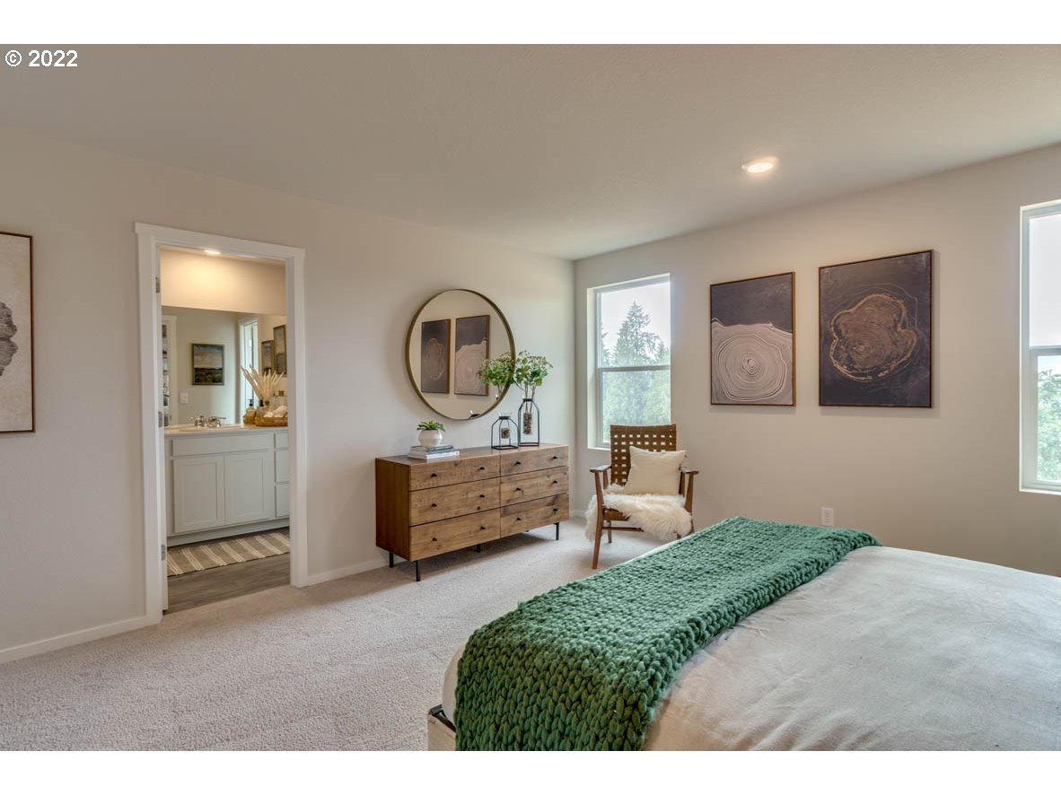 228 North 30th Drive Ridgefield, WA 98642 - Photo 17 of 24 a bedroom with a large bed and a dresser