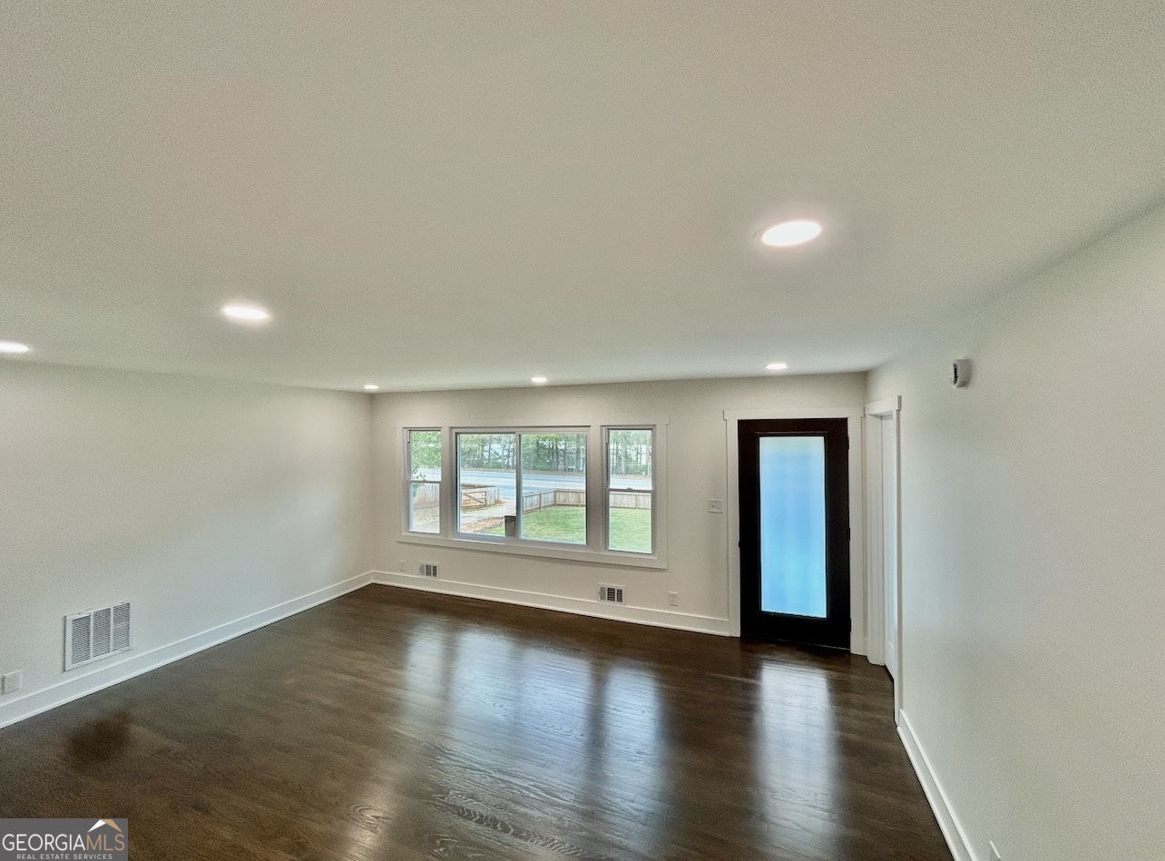 1742 Constitution Road Southeast Atlanta, GA 30316 - Photo 5 of 32 an empty room with wooden floor and windows