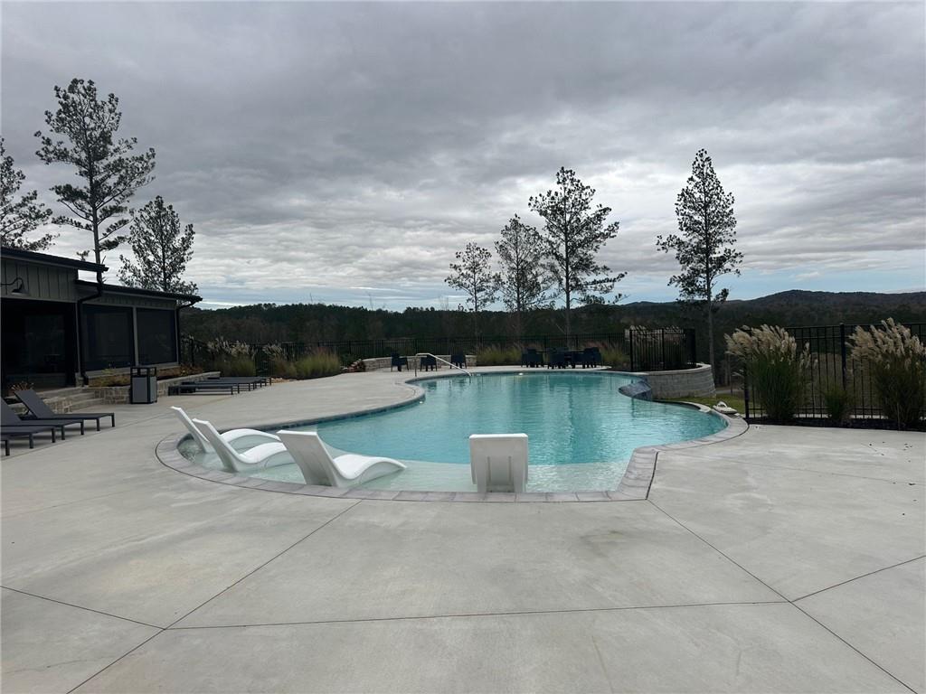 Lot 04 Blalock Mountain Road Talking Rock, GA 30175 - Photo 11 of 18 a view of a lake with a bench and trees