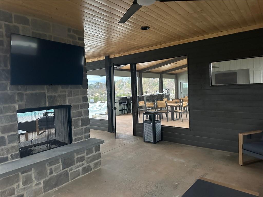 Lot 04 Blalock Mountain Road Talking Rock, GA 30175 - Photo 6 of 18 a living room with furniture a flat screen tv and a fireplace