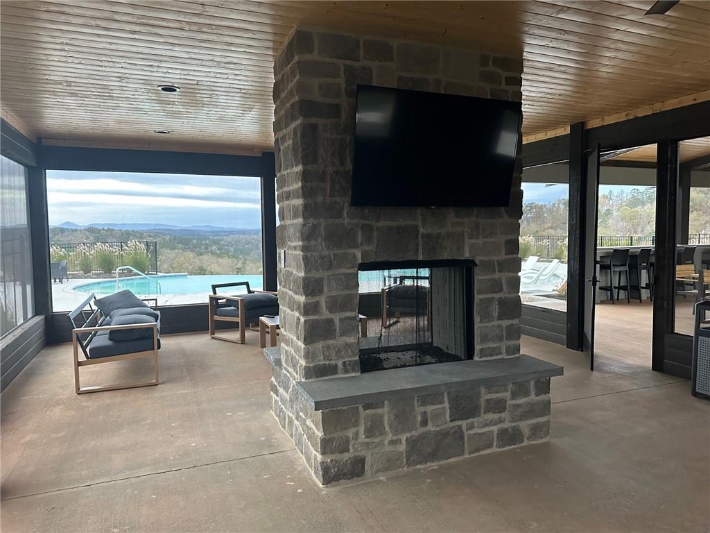 Lot 04 Blalock Mountain Road Talking Rock, GA 30175 - Photo 7 of 18 a living room with fireplace furniture and a flat screen tv