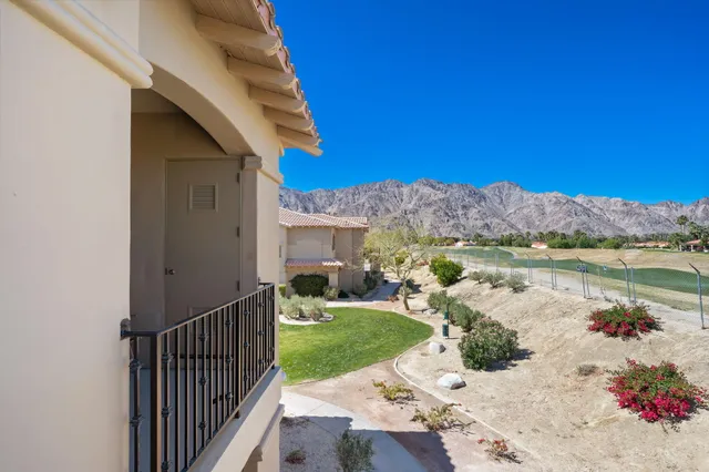 a view of a house with a yard and balcony
