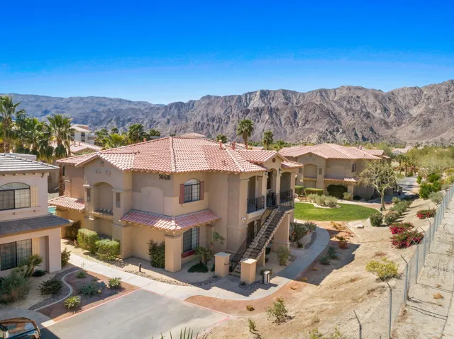 an aerial view of a house with a yard and lake view