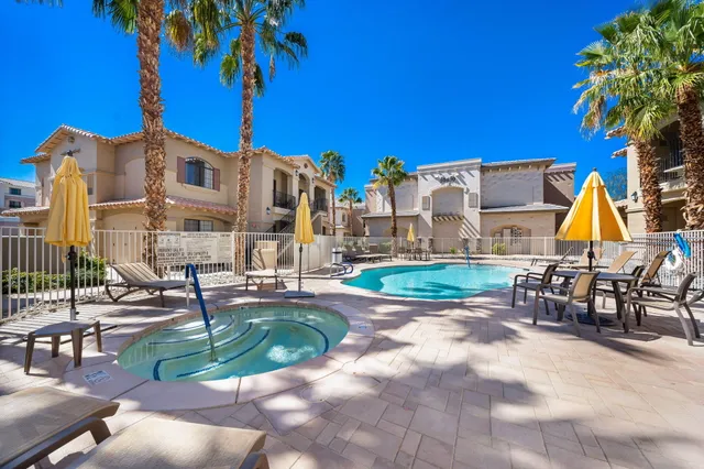 a view of a house with a swimming pool and sitting area
