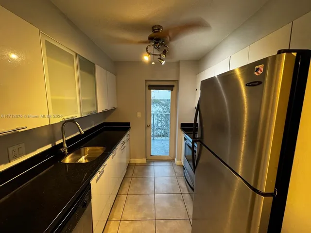 a kitchen with a refrigerator and a sink