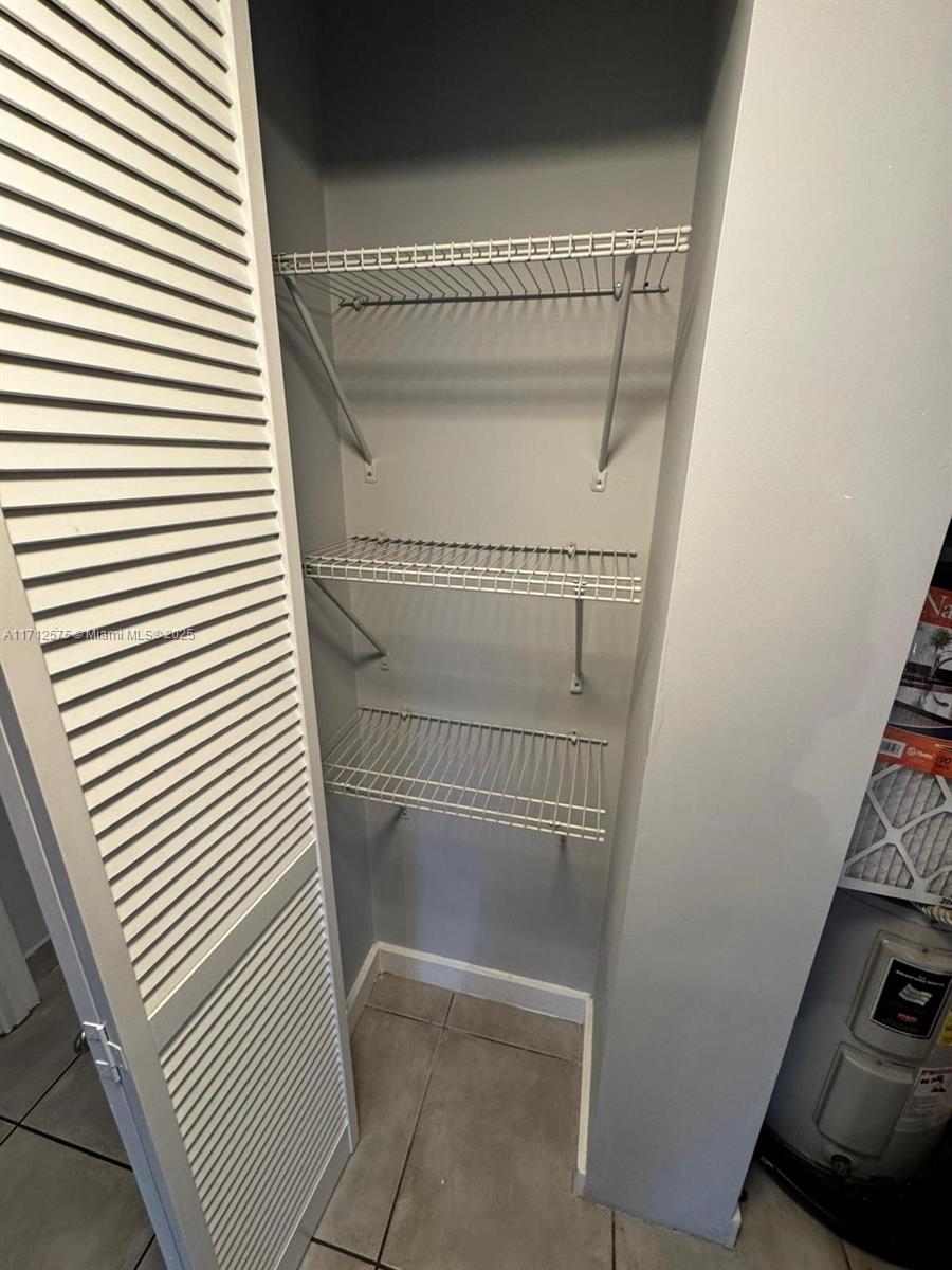 650 Northeast 64th Street, Unit G503 Miami, FL 33138 - Photo 20 of 22 a view of a room with racks on the wall
