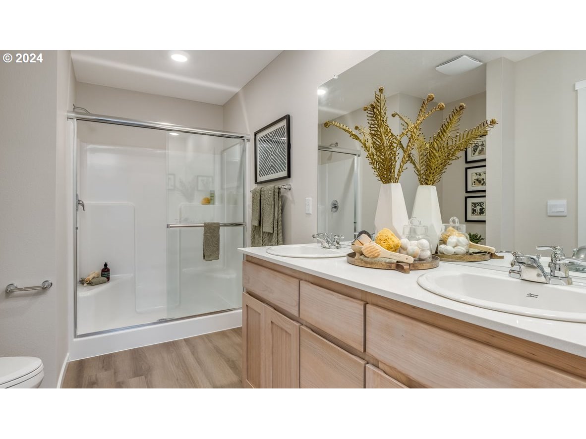 1555 Southeast Pheasant Avenue Gresham, OR 97080 - Photo 28 of 32 a bathroom with a sink a mirror and a shower