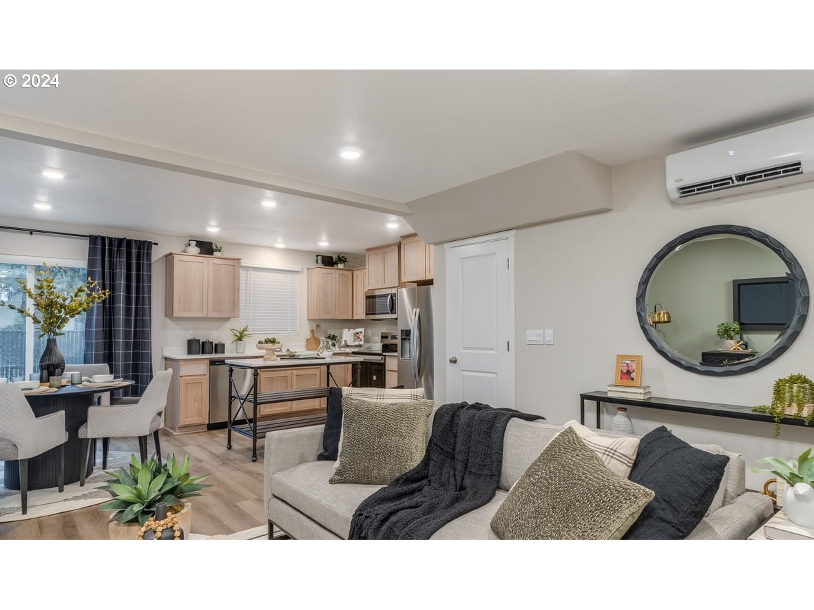 1555 Southeast Pheasant Avenue Gresham, OR 97080 - Photo 6 of 32 a living room with stainless steel appliances kitchen island granite countertop a table chairs and a view of living room