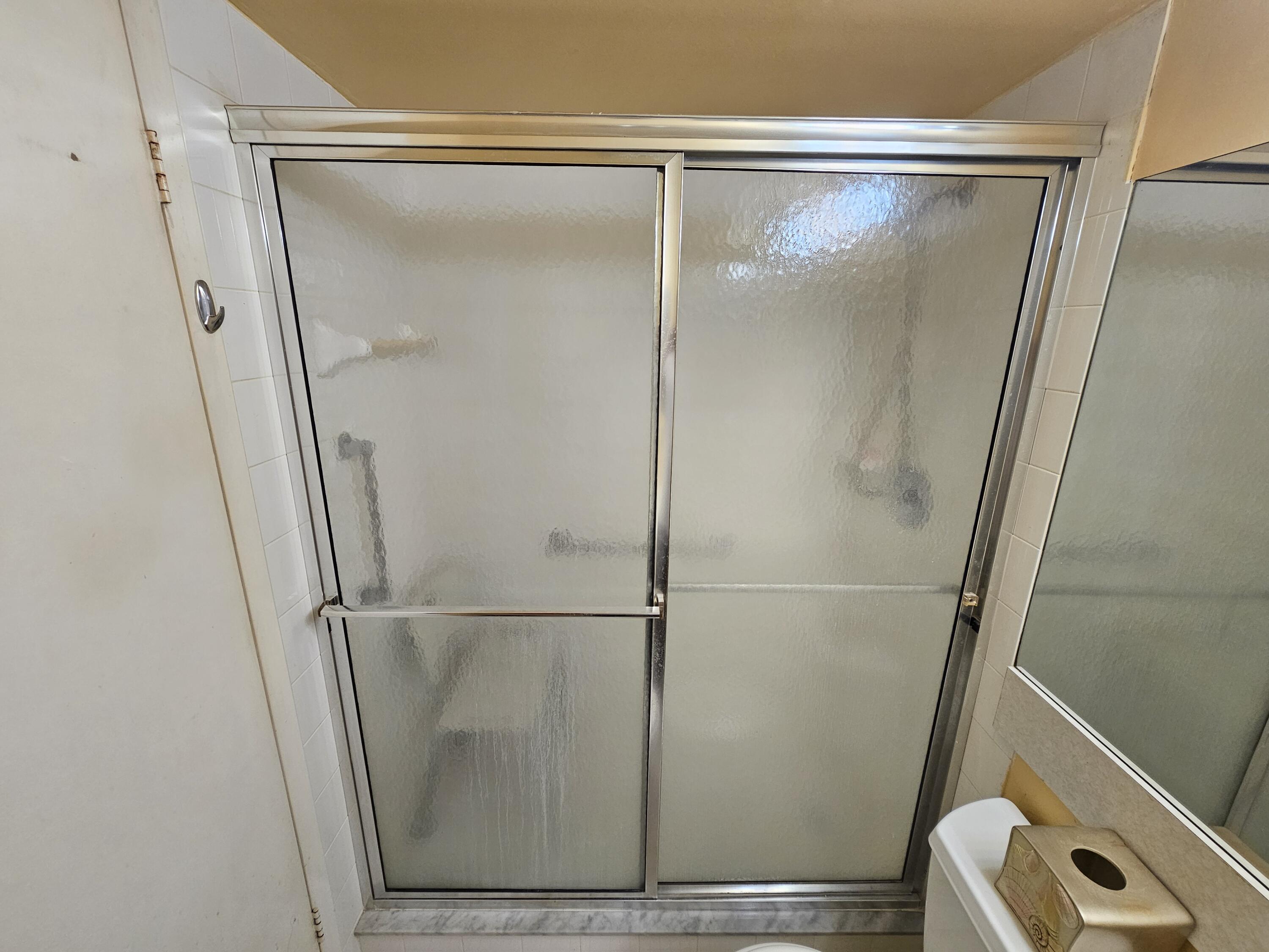 3055 Ainslie Drive, Unit 3055 Boca Raton, FL 33434 - Photo 11 of 26 a bathroom with a glass shower door