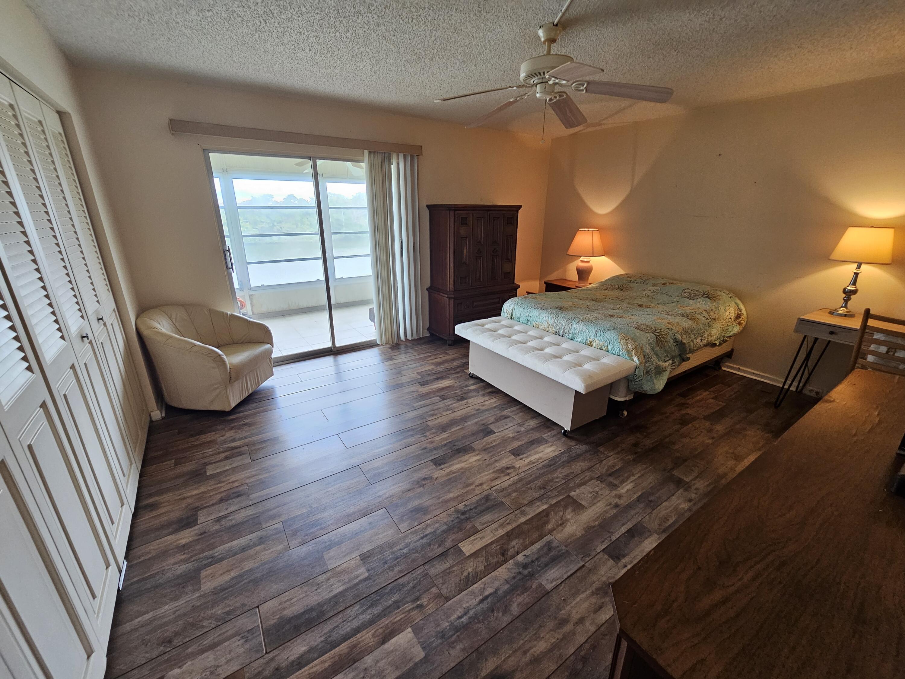 3055 Ainslie Drive, Unit 3055 Boca Raton, FL 33434 - Photo 9 of 26 a living room with furniture rug and wooden floor