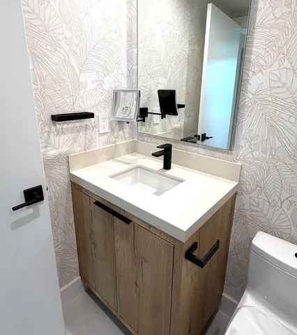 a bathroom with a toilet and a sink