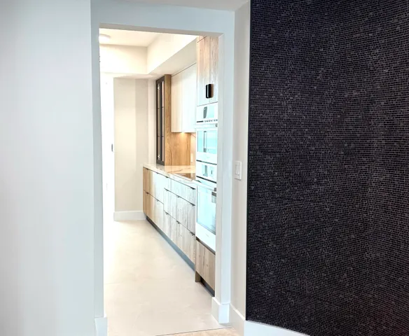 a en suite bathroom with a granite countertop sink and a mirror