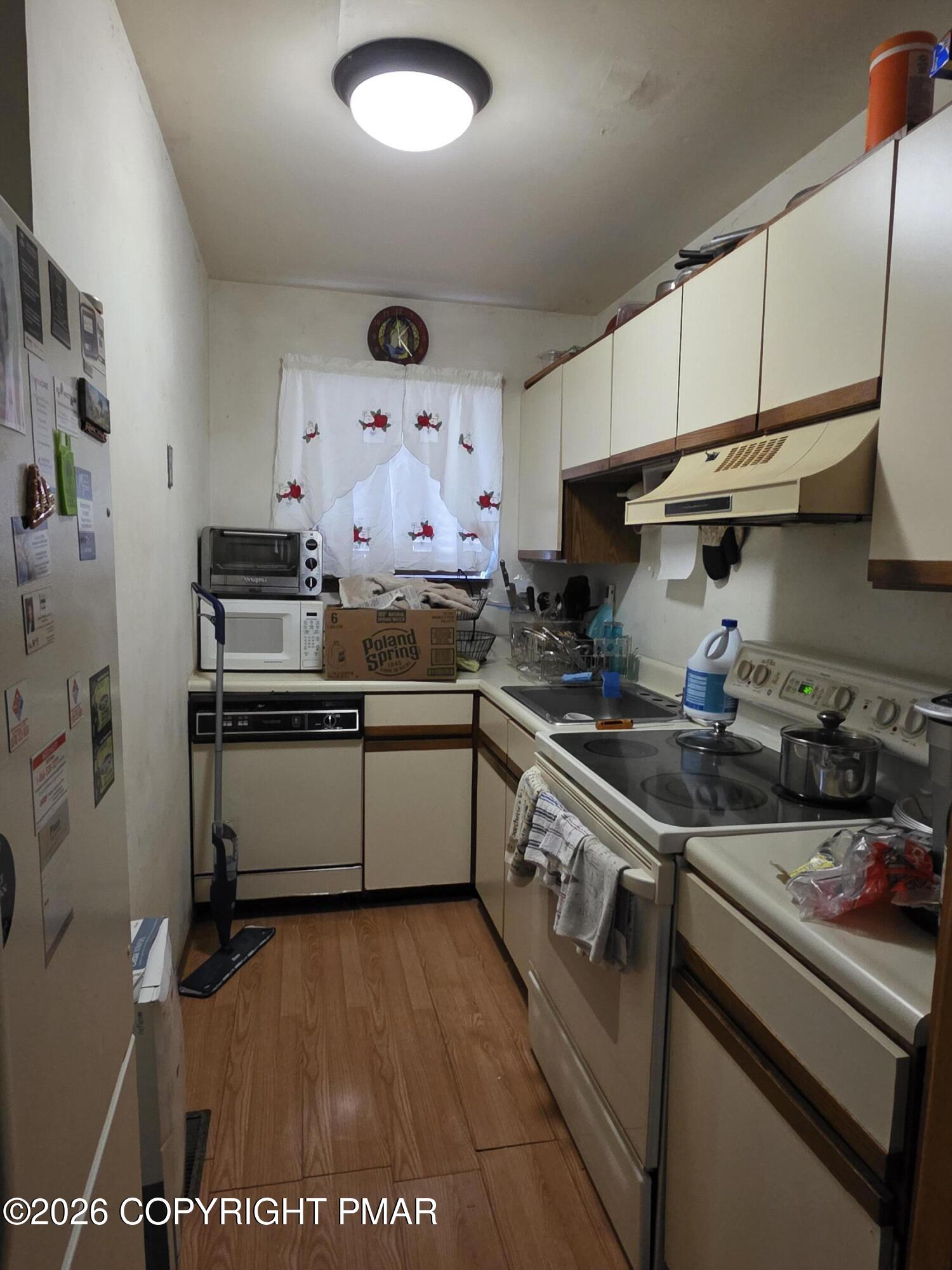 503 English Court Bushkill, PA 18324 - Photo 7 of 14 a kitchen with stainless steel appliances granite countertop a stove a sink and a refrigerator
