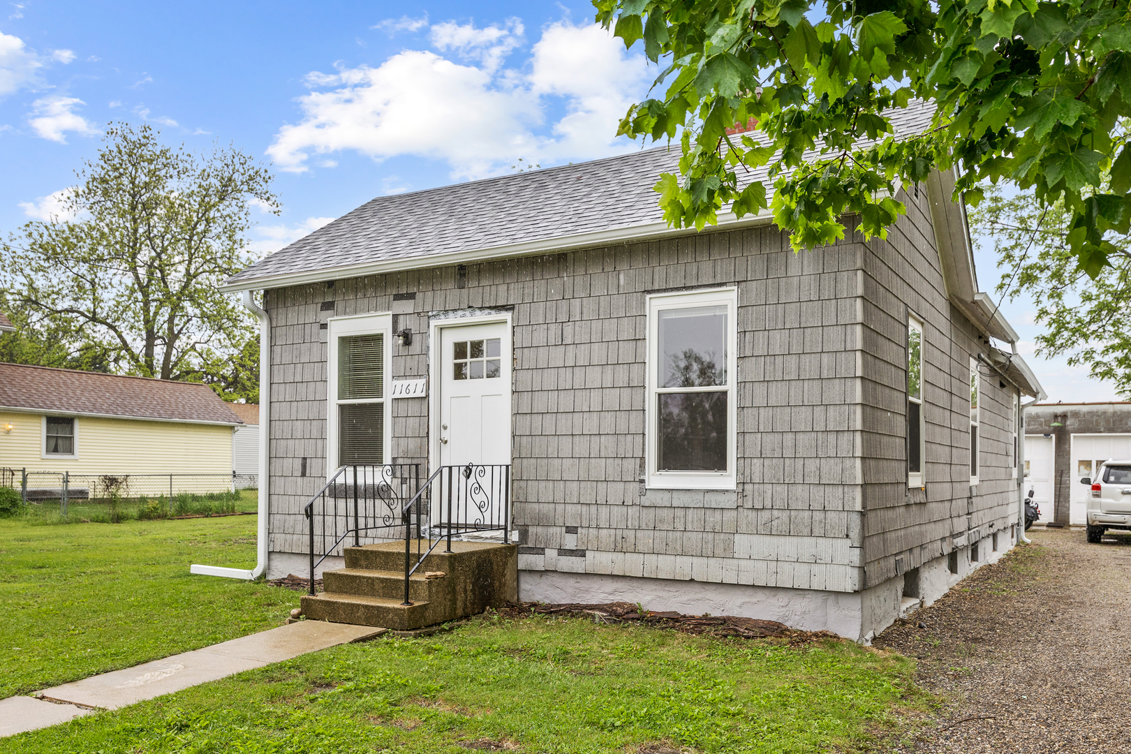 a front view of a house with a garden