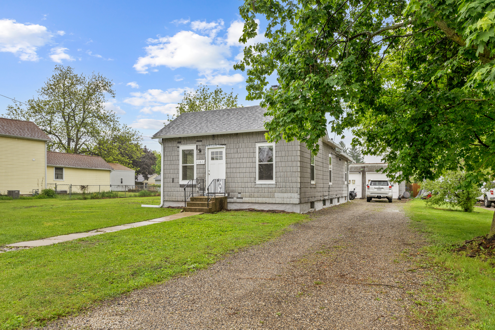 11611 Maple Avenue Hebron, IL 60034 - Photo 2 of 23 a view of a house with a yard and a large tree