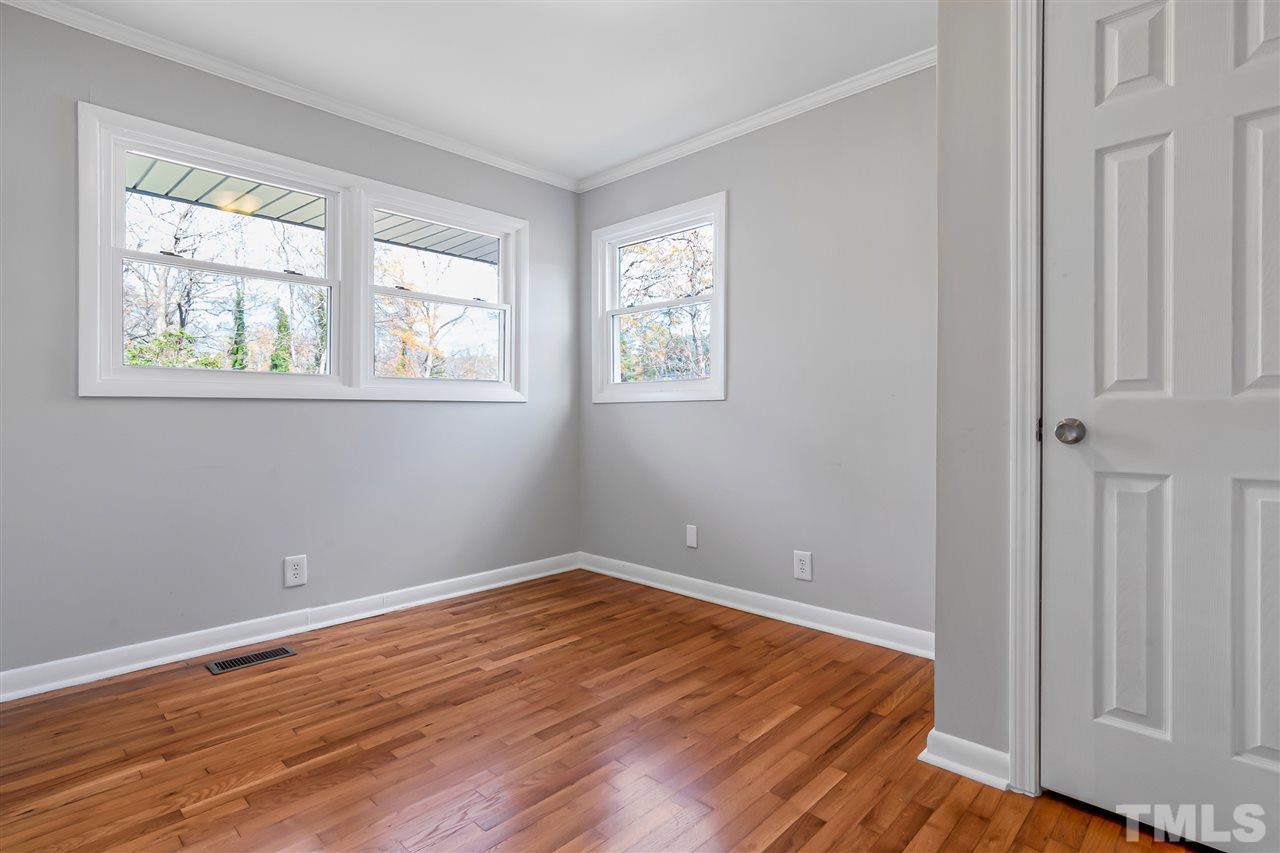 664 Semora Road Roxboro, NC 27573 - Photo 11 of 13 wooden floor in an empty room with a window