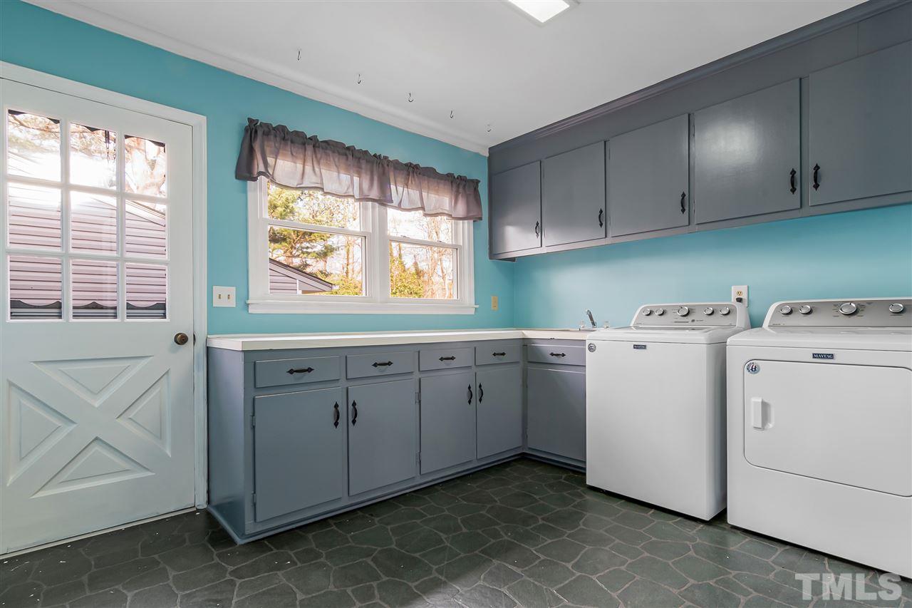 664 Semora Road Roxboro, NC 27573 - Photo 13 of 13 a utility room with cabinets washer and dryer